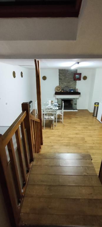 a room with a staircase and a table and a piano at Le spacieux in Cherbourg en Cotentin