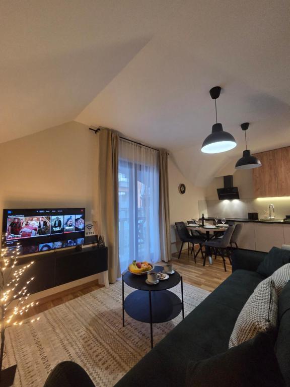 a living room with a couch and a table at Tara Breeze Apartments in Kolašin