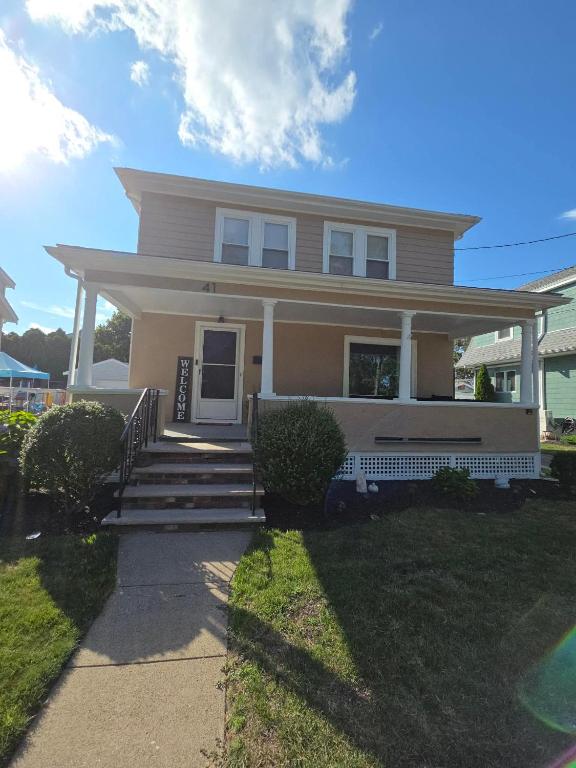 a house with a porch and stairs in front of it at The Fairview - North of Boston Furnished Home in Peabody