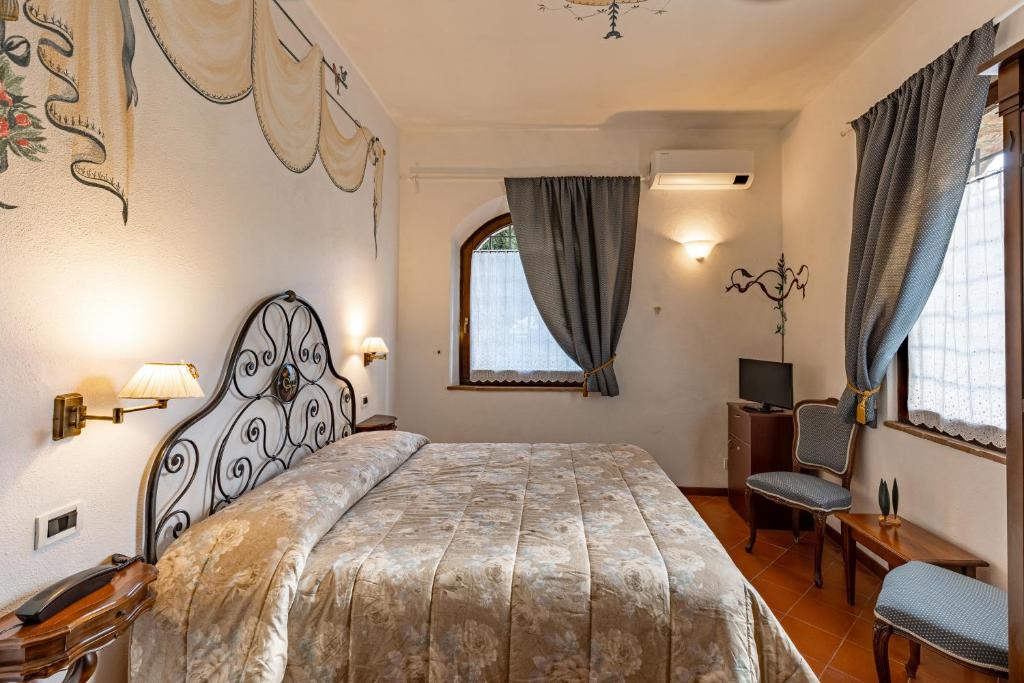 Ένα ή περισσότερα κρεβάτια σε δωμάτιο στο Hotel Vecchia Oliviera
