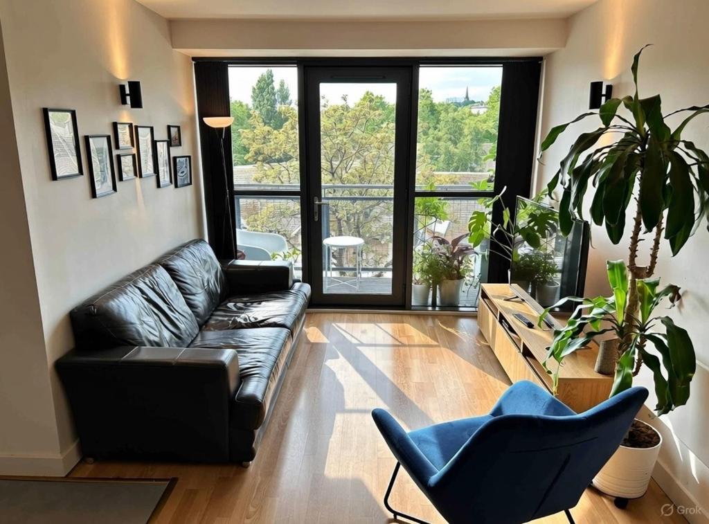 a living room with a leather couch and a blue chair at Sheffield City Centre Apartment & Balcony in Sheffield
