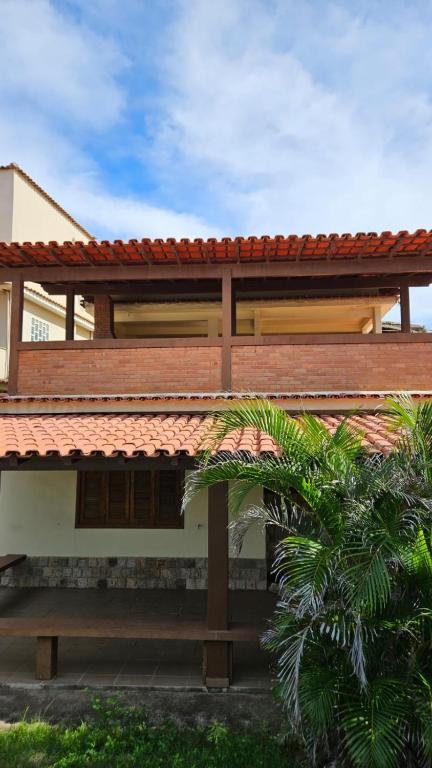 a house with a red tiled roof at Casa com piscina Perto Da Praia Em FIGUEIRA in Arraial do Cabo