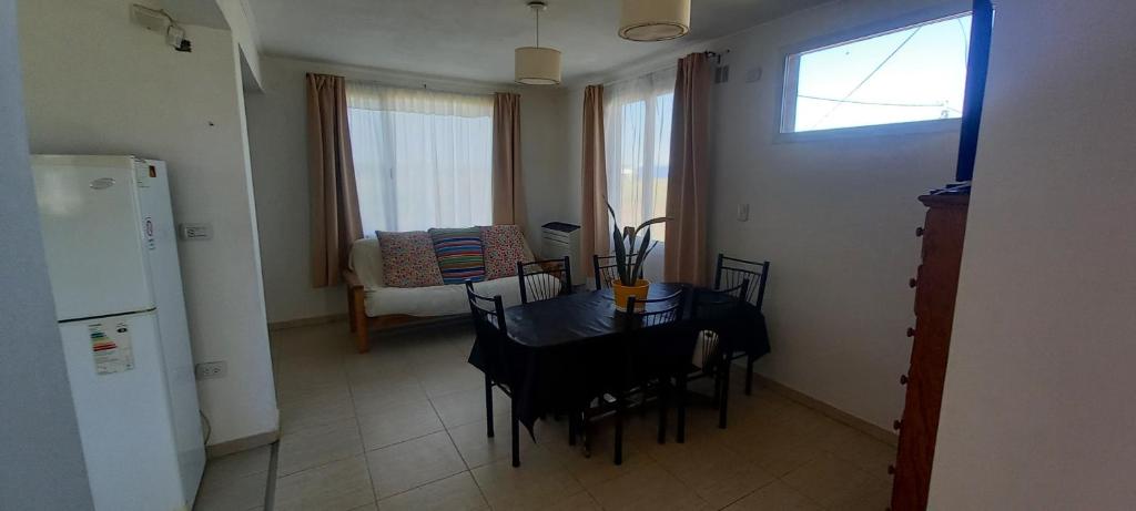 a kitchen with a dining room table and a table and chairs at El Chalten hospedaje diario in General Pico