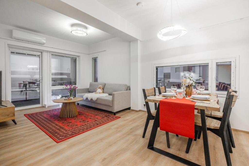 a living room with a table and chairs and a couch at Lapland Apartment in Rovaniemi