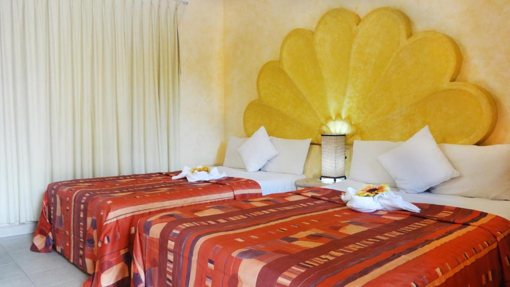 En eller flere senge i et værelse på Villas La Lupita