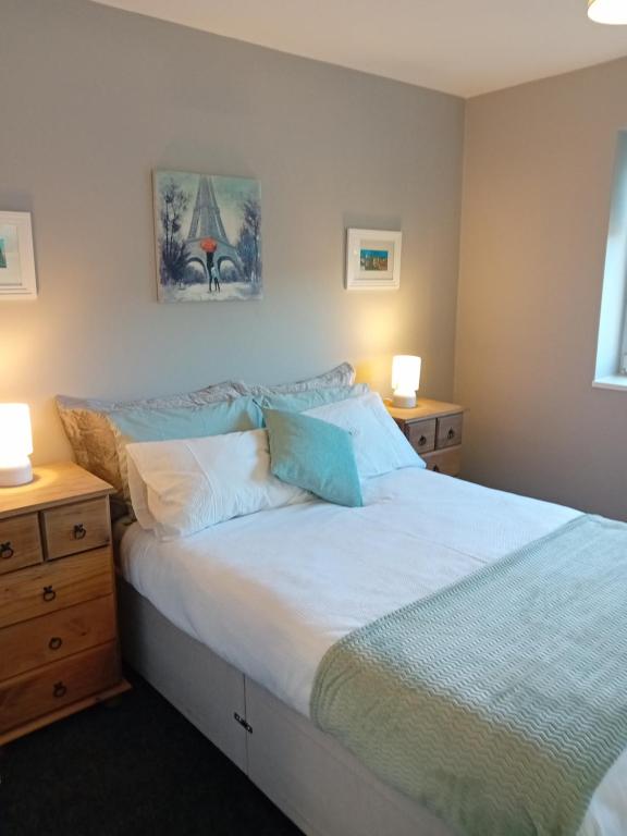 a bedroom with a bed with two night stands and two lamps at Luxurious Double En-Suite Tralee Town Centre in Tralee