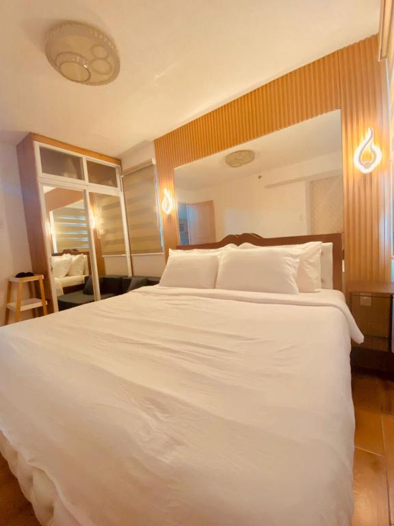 a large white bed in a hotel room at MD Suite by Seawind in Davao City