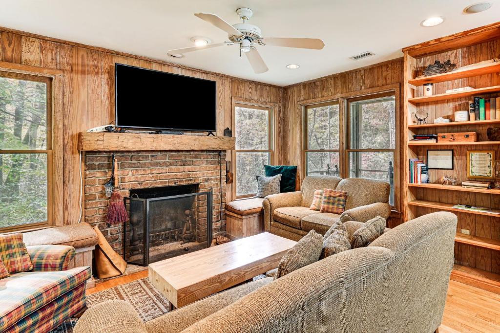 een woonkamer met een open haard en een flatscreen-tv bij Relax Creekside Forest-View Gem in Marietta! in Riverview
