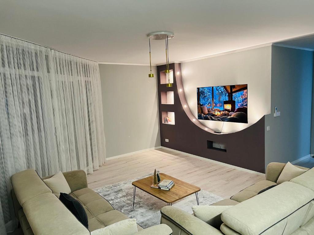 a living room with a couch and a table at City View Apartment in Mitrovicë