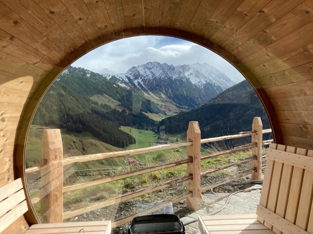an arched window with a view of mountains at Siedelhütte in Gerlos