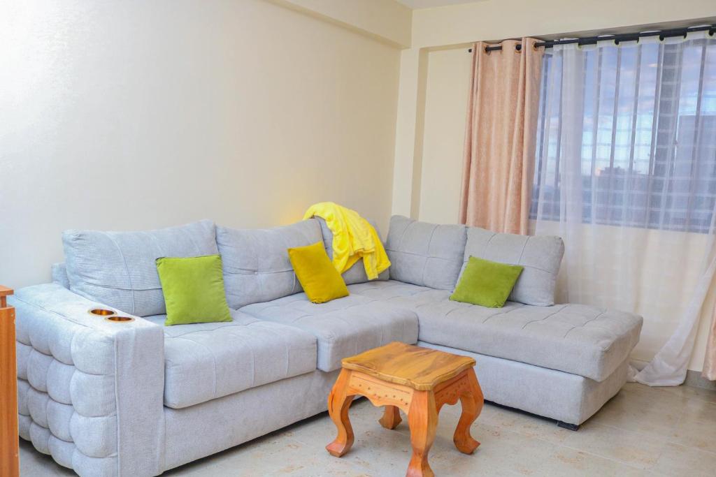 a living room with a couch and a table at Nanyukihomes3 in Nanyuki