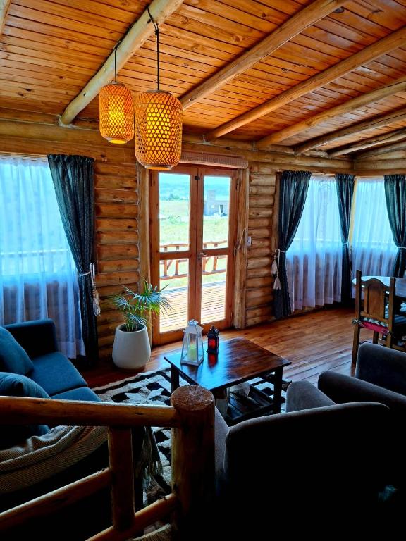 a living room with a couch and a table at La Autóctona in Villa Yacanto
