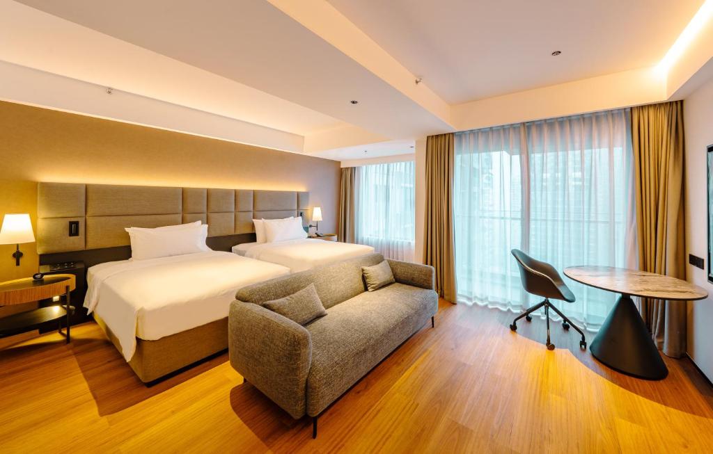 Postel nebo postele na pokoji v ubytování Intercity Hotel & Serviced Apartment Phnom Penh Downtown