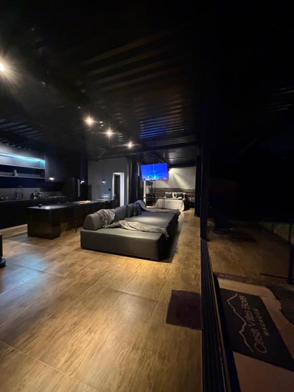 a living room with a couch and a television at Casa Vilas Boas Macacos in Nova Lima