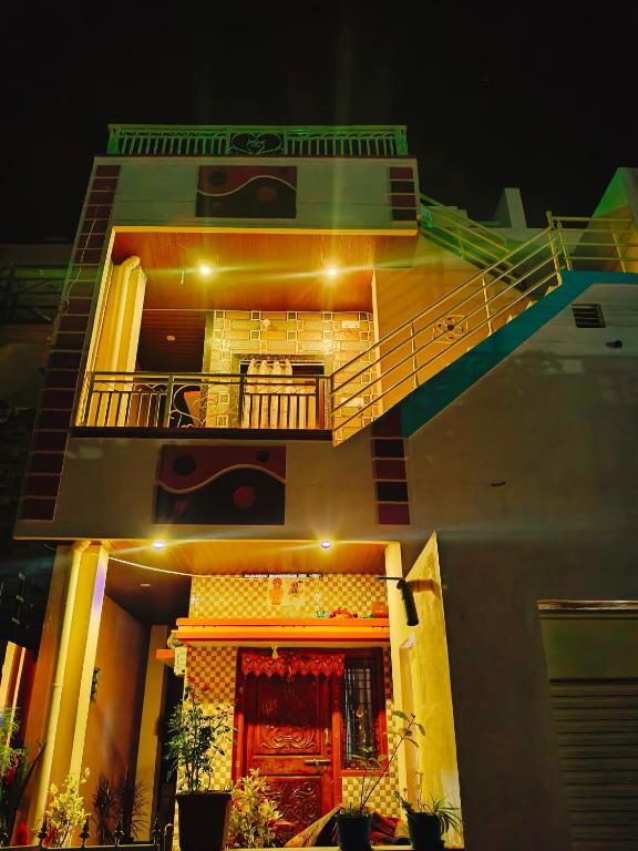 a large house with a balcony and a porch at Sumathi homestay in Hospet