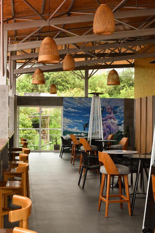 a restaurant with tables and chairs and a painting on the wall at Phuyu Hotel in Mendoza