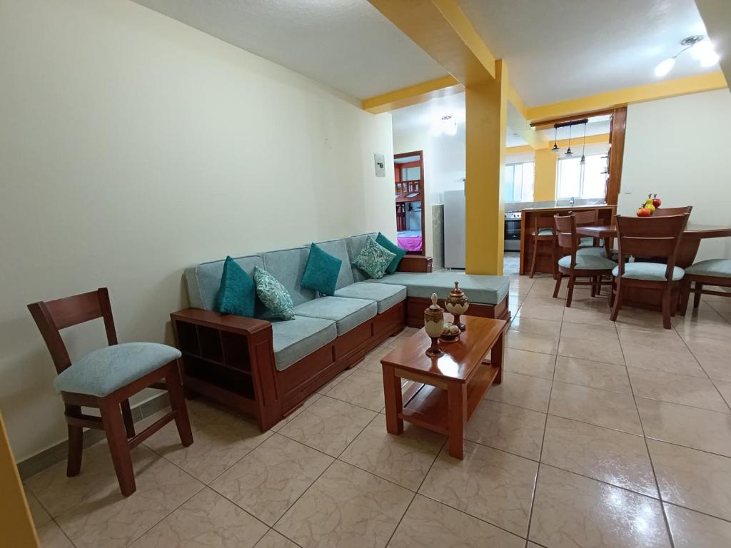 a living room with a couch and chairs and a table at Departamento Amazonia Ecuador in Puyo