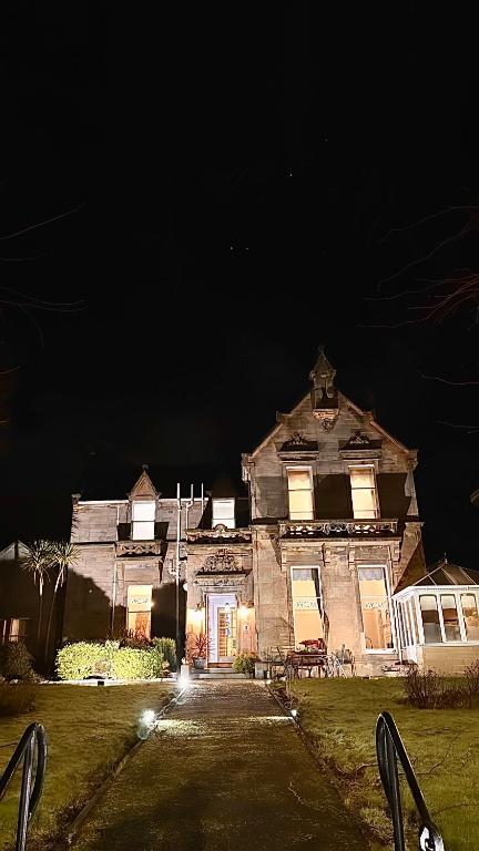 an old house at night with its lights on at West Coates Mansion in Edinburgh