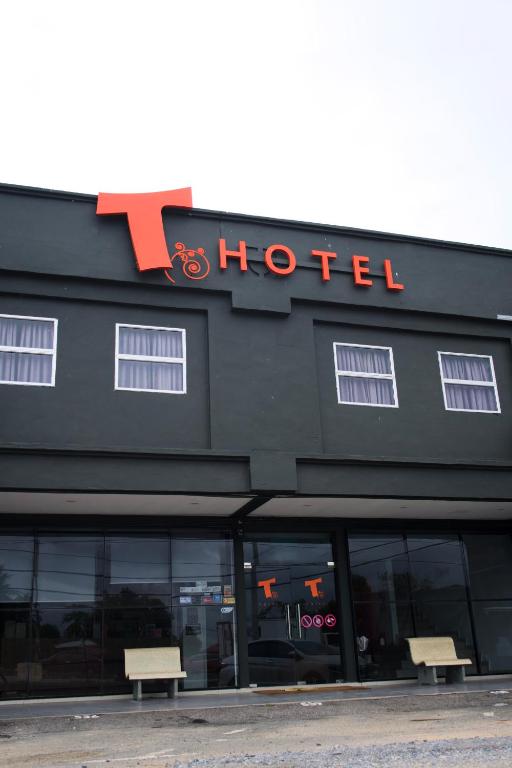 a hotel building with two benches in front of it at T Hotel Tandop in Alor Setar