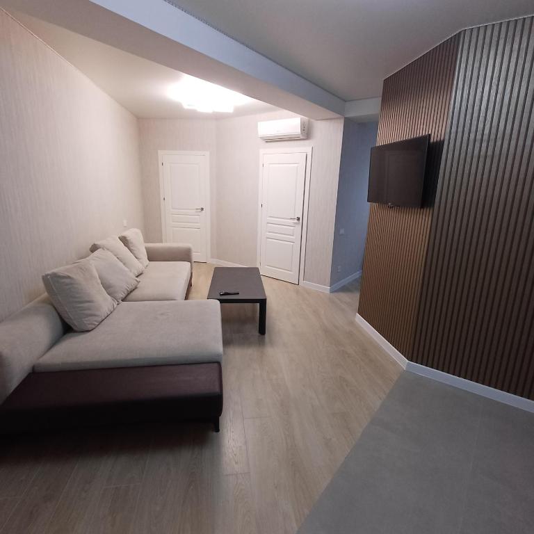 a living room with a couch and a table at Apartament Buiucani Alba Iulia in Chişinău
