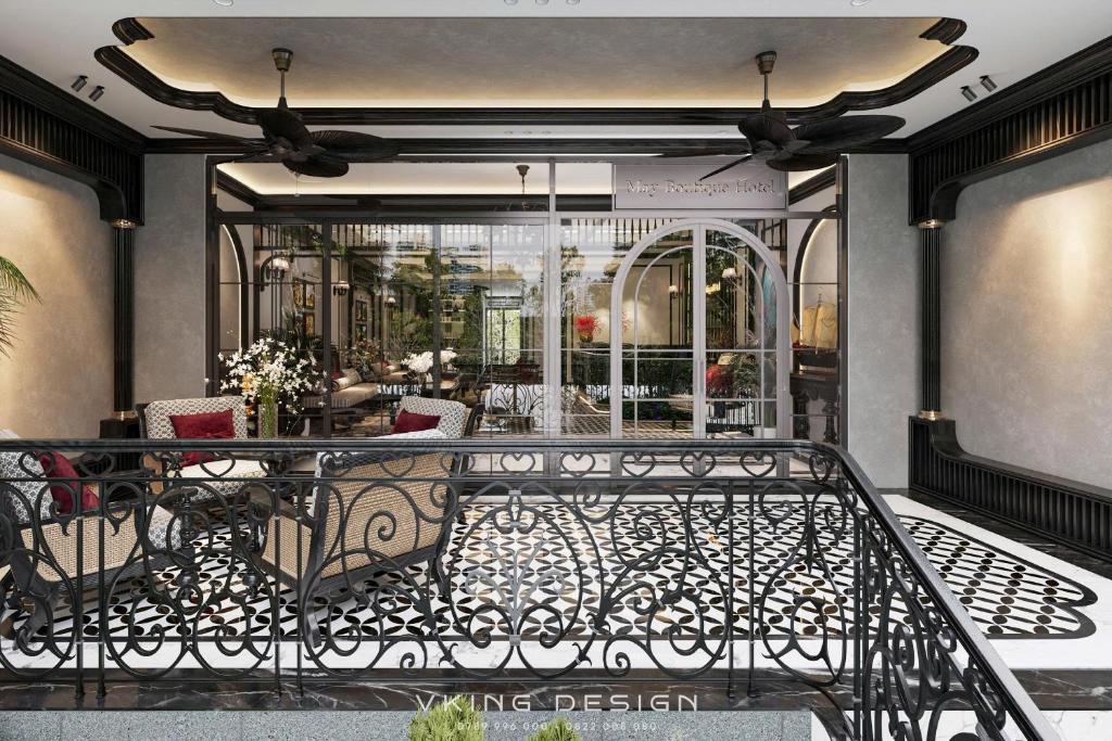 May Boutique DongVan Hotel في دونغ فان: شرفة بها طاولة وكراسي في متجر