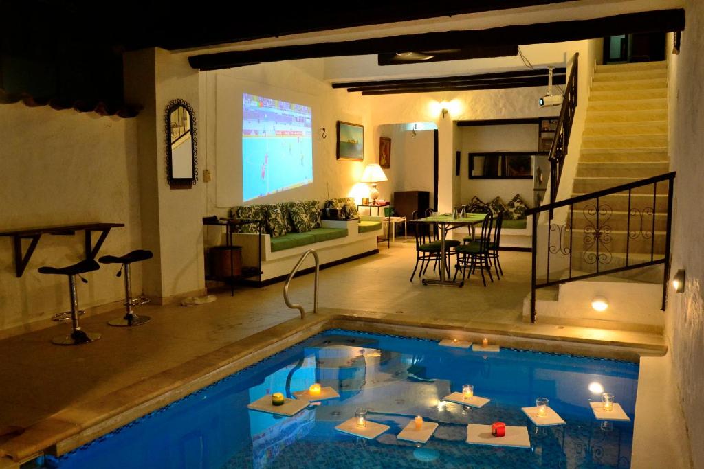 a house with a swimming pool in a living room at Casa Los Almendros in Melgar