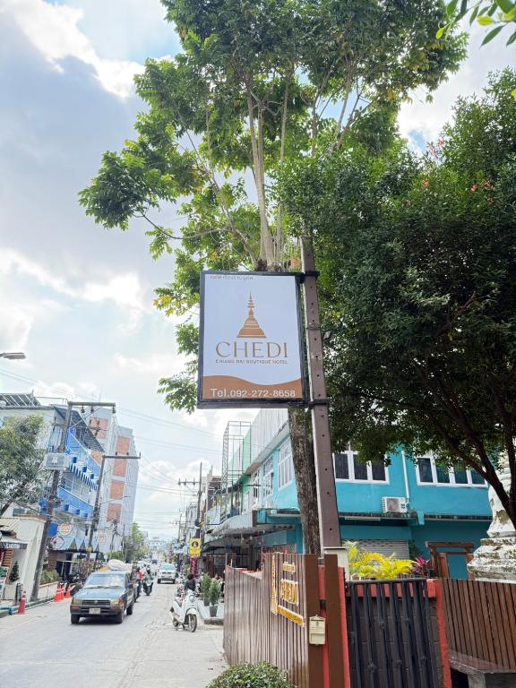 a sign on a pole on a city street at Chedi Chiangrai Boutique Hotel in Chiang Rai