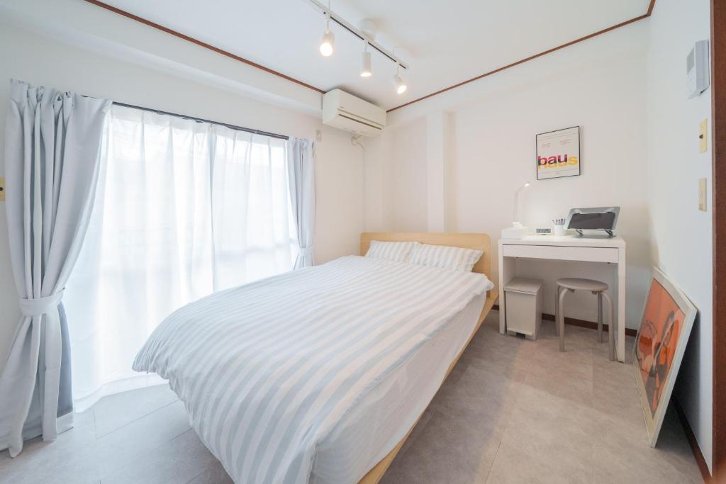 a white bedroom with a bed and a desk at 3min walk to Asagaya Sta, Cozy Private Studio Direct access 8min to Shinjuku, 30min to Akihabara and Asakusa in Tokyo