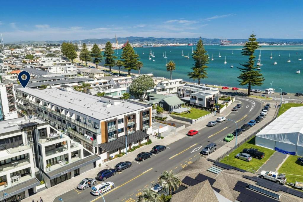 an aerial view of a city with a road and buildings at 2 Room Luxury Beach Escape 112sq Mt Maunganui in Mount Maunganui