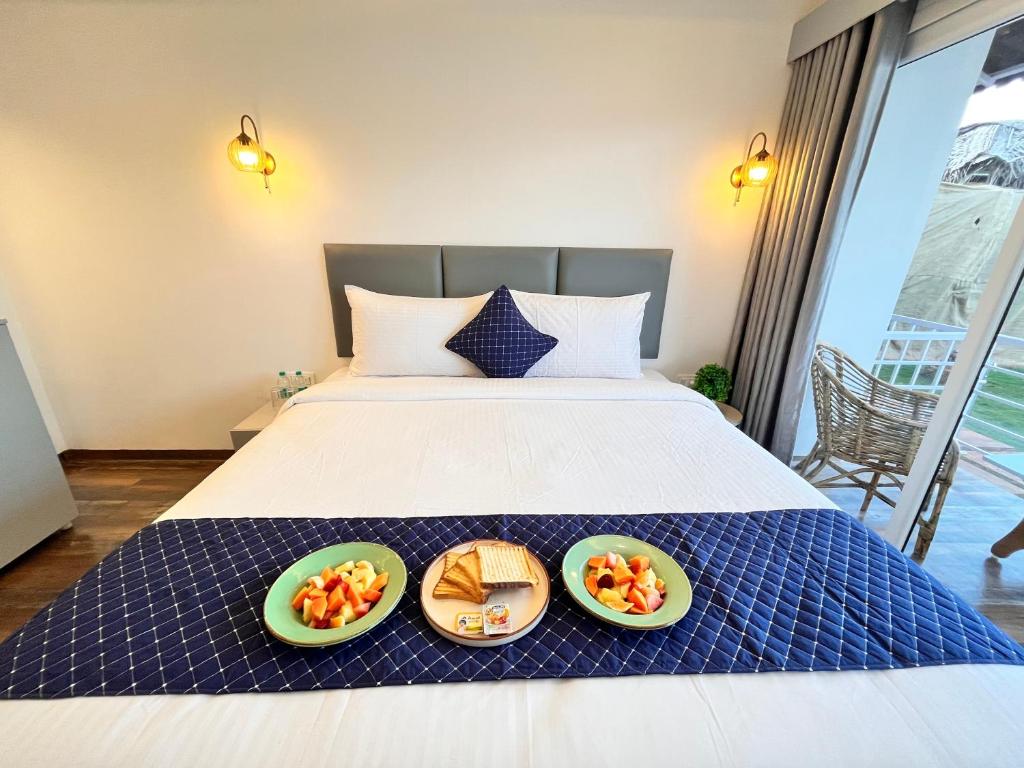 En eller flere senge i et værelse på The Coastal Agonda