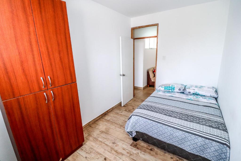 En eller flere senge i et værelse på CERRO AZUL Alojamiento - Mini 4 personas