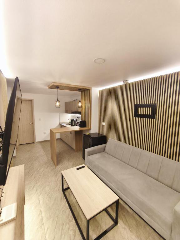 a living room with a couch and a table at Barranquero Coffee Loft in Santa Rosa de Cabal