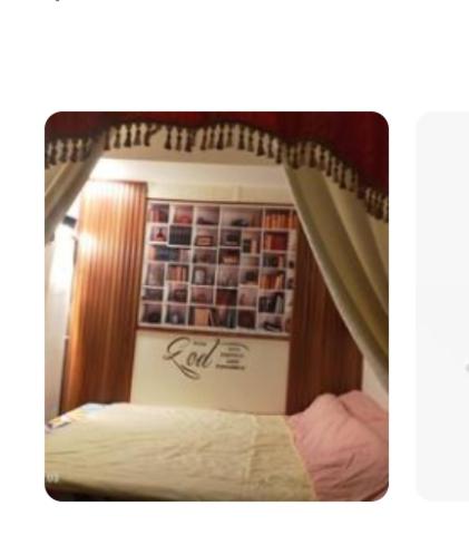 a mirror on a bed in a bedroom at JC Palace Residences in Manila