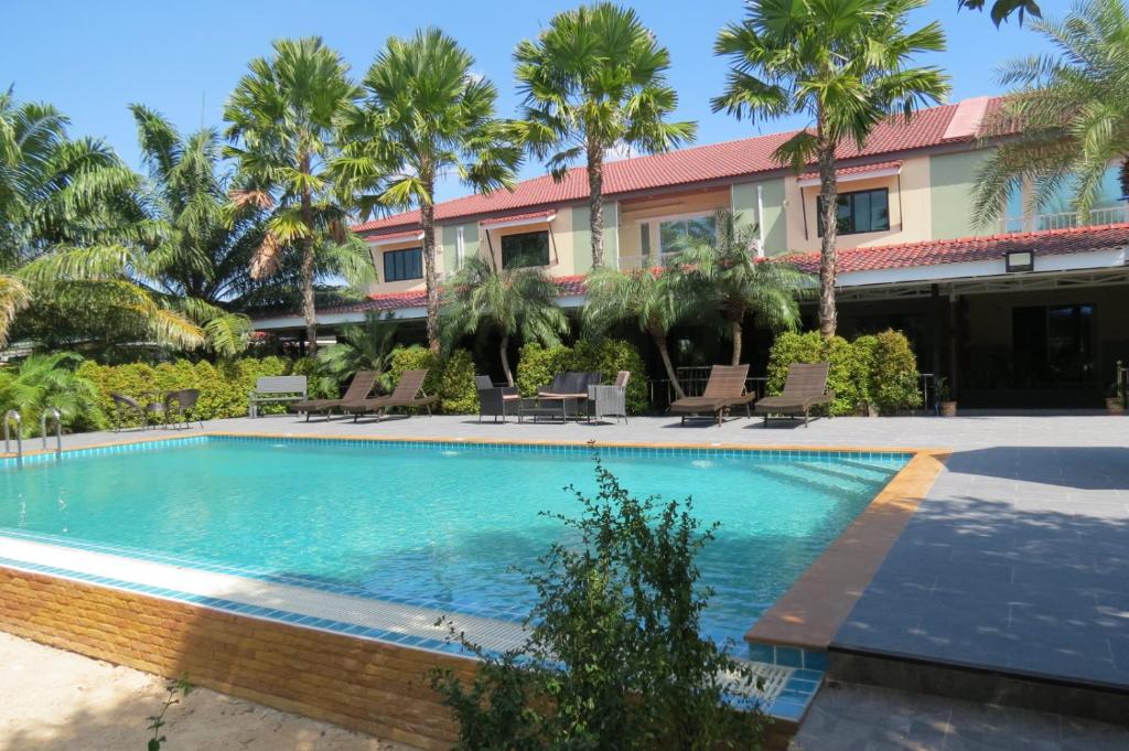 a swimming pool in front of a resort at Baan Bee Residence in Nong Prue