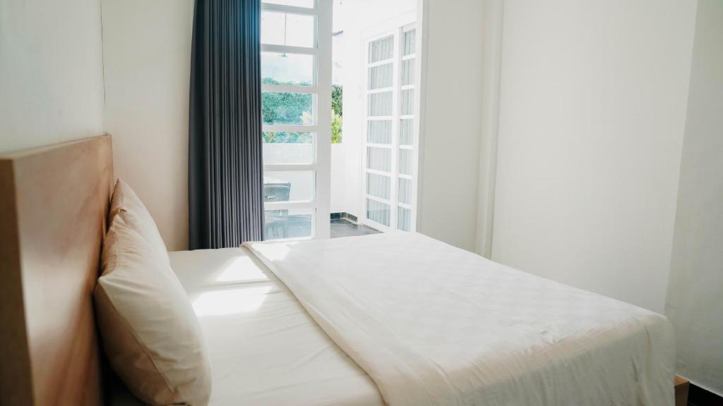 En eller flere senge i et værelse på Apartment Nata Umalas