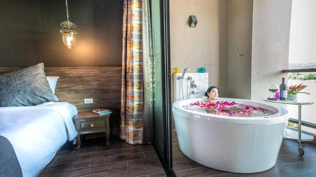 Postel nebo postele na pokoji v ubytování Chiangkhong Teak Garden Riverfront Onsen Hotel- SHA Extra Plus