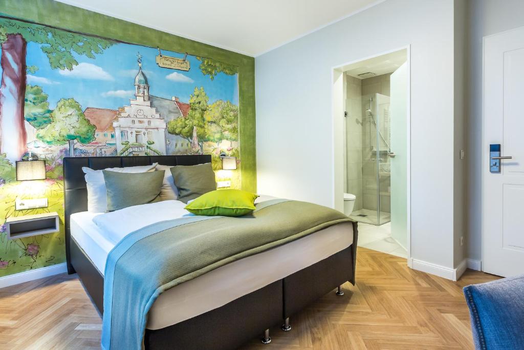 a bedroom with a bed with a painting on the wall at Burghotel Lingen in Lingen