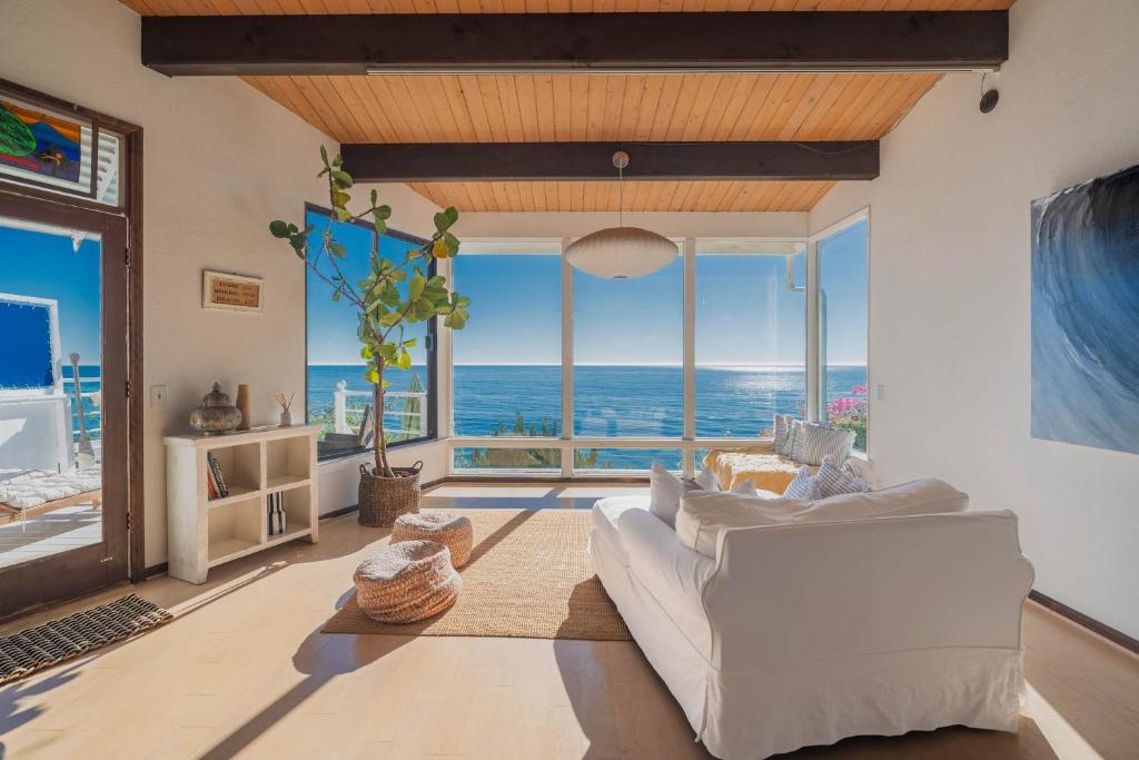 a living room with a white couch and a view of the ocean at Malibu Villa with Beach Access and Ocean View in Malibu