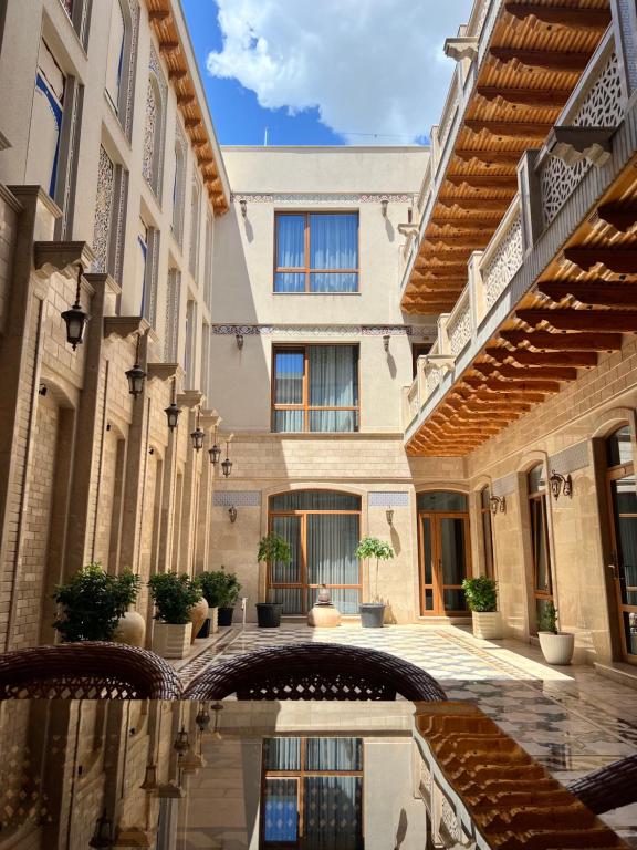 a courtyard with a pool in a building at Premium Hotel Labi Rud in Bukhara