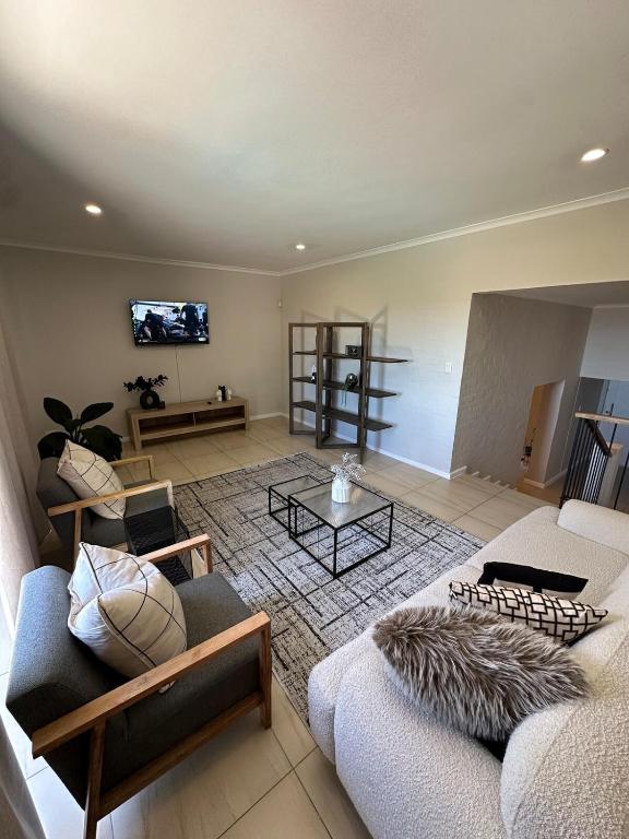 a living room with two couches and a tv at Little Nest in Somerset West