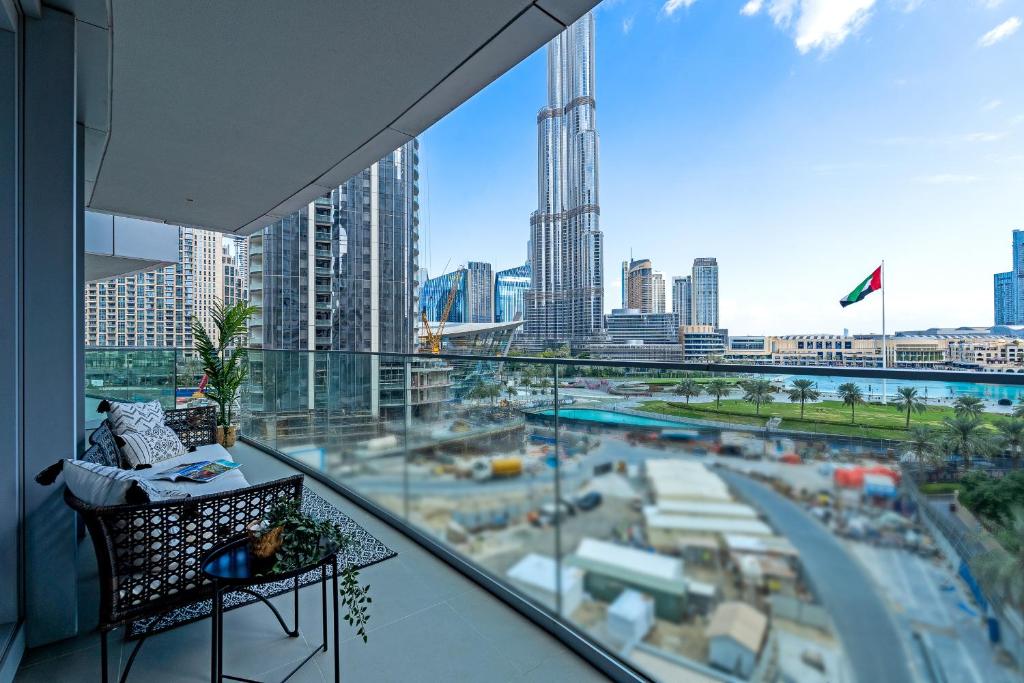a balcony with a view of a city skyline at Vogue Vacation Homes, Downtown Opera Grand near Burj Khalifa and Dubai Mall, Two Bedroom Apartment with Large Balcony and Burj Khalifa view, Access to all Amenities in Dubai