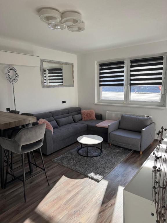 a living room with a couch and a table at Appartement Märzenkeller in Murau