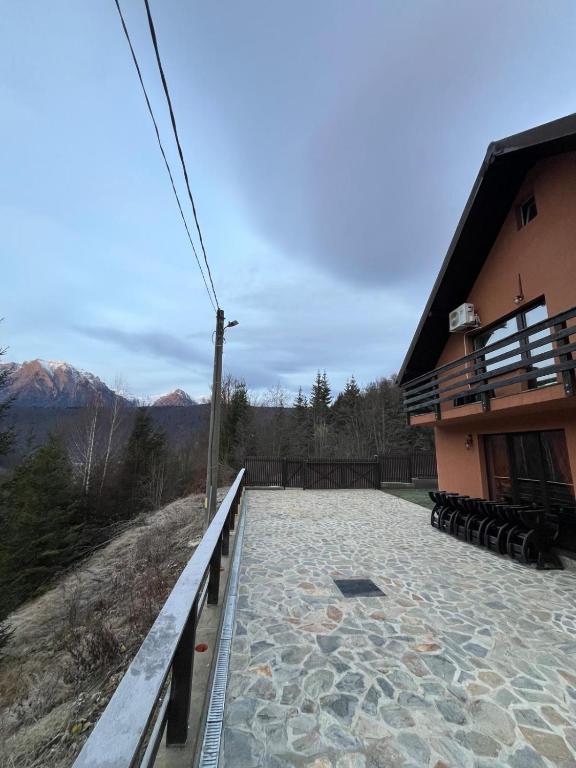 a balcony of a house with mountains in the background at Vila Soleil in Azuga