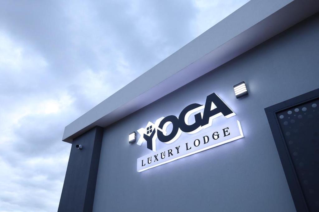 a sign on the side of a building at Yoga Luxury Lodge in Thohoyandou