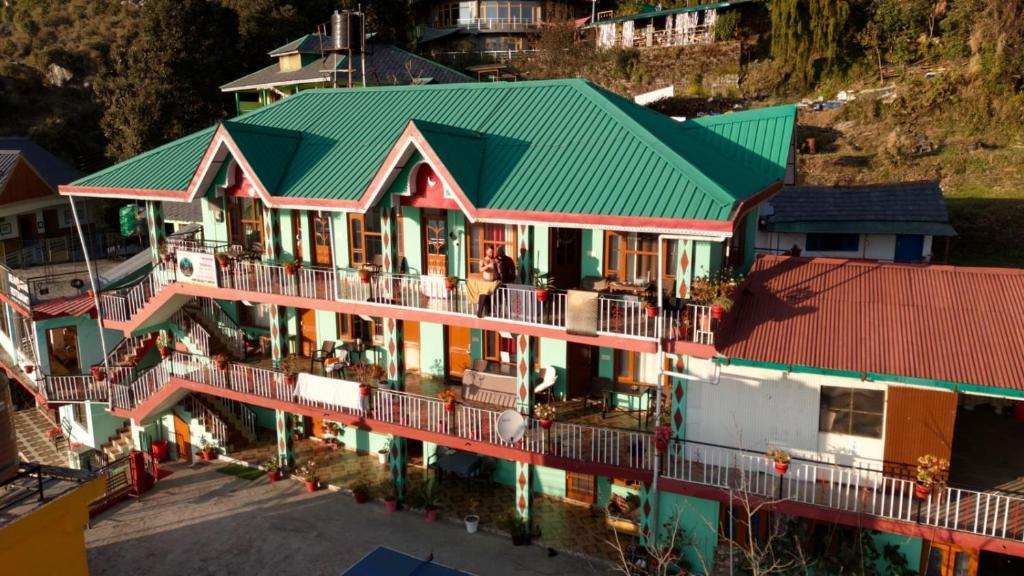 an aerial view of a building with a green roof at dreamcatcher homestay in Jāmb