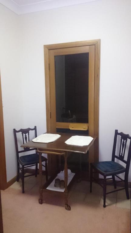 a dining room with a table and two chairs at Gaerwood B&B in Keith