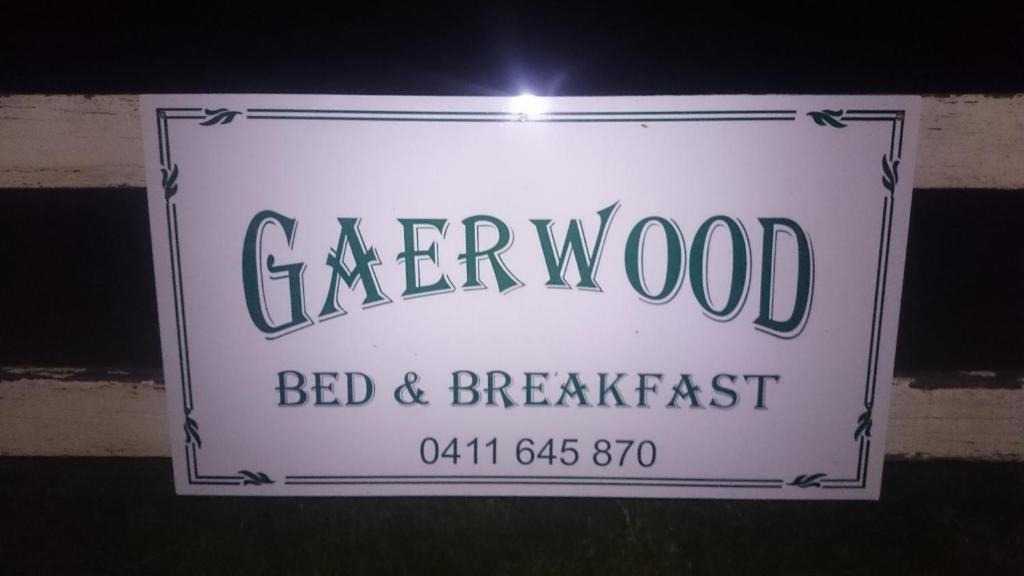 a sign for a bed and breakfast on a wall at Gaerwood B&B in Keith