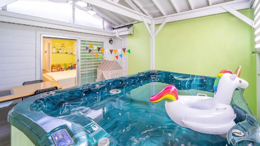 a pool with a inflatable duck in a room at Gapyeong Yeheaden Pension in Pocheon