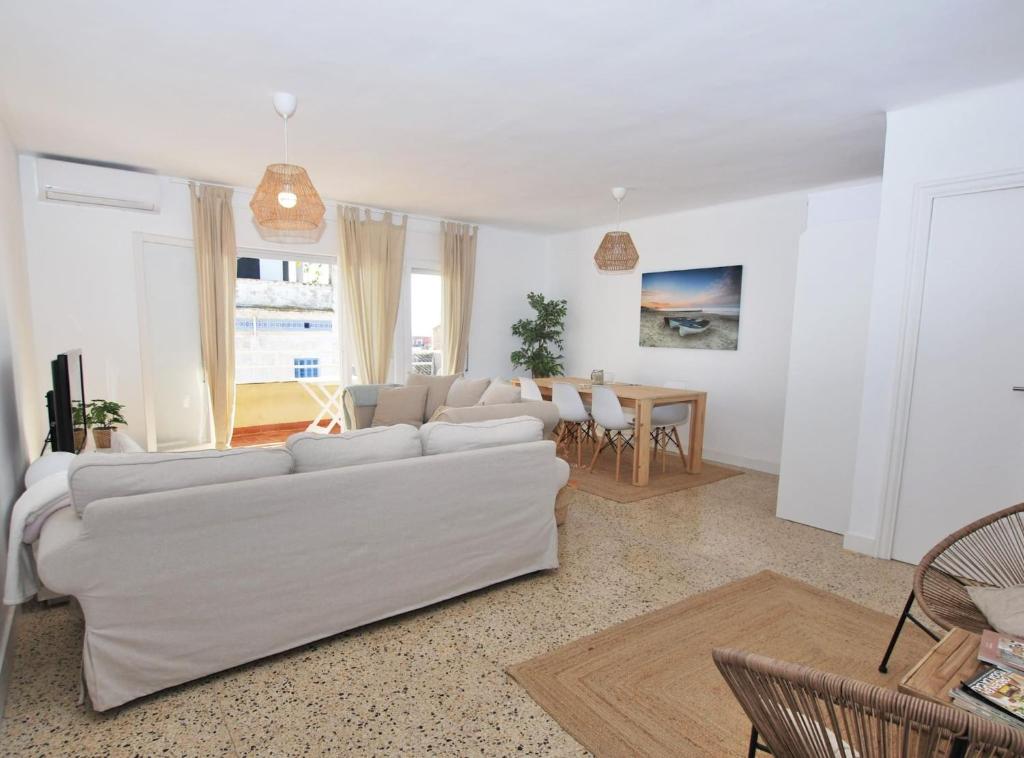 a living room with a white couch and a table at Can Josep in Vilassar de Mar