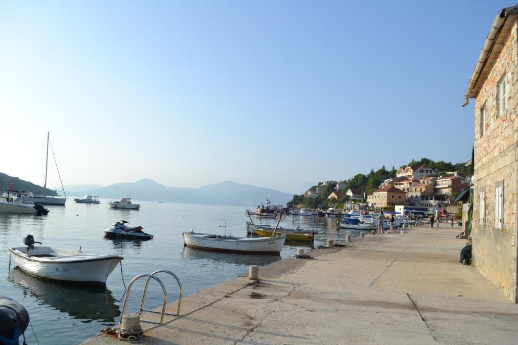 a group of boats are docked in a harbor at Suntime Villаs in Tivat